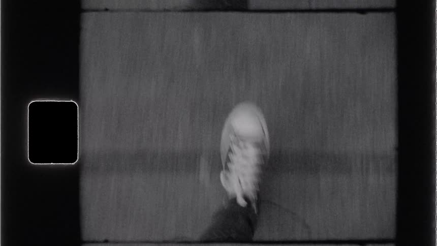 Legs of a person walking on a tarred road in the morning