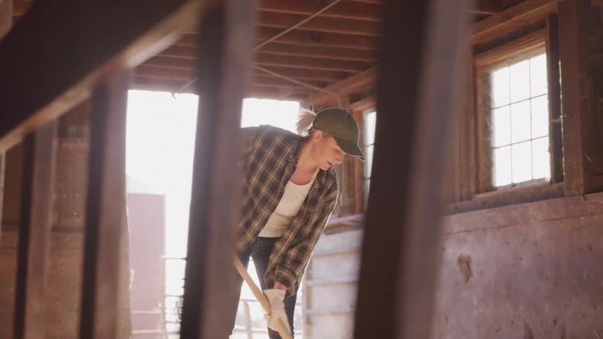 Woman cleaning a wooden hut