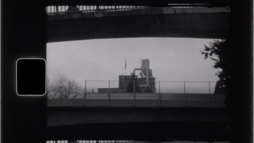Building in a city with bridges in the foreground on an urban highway