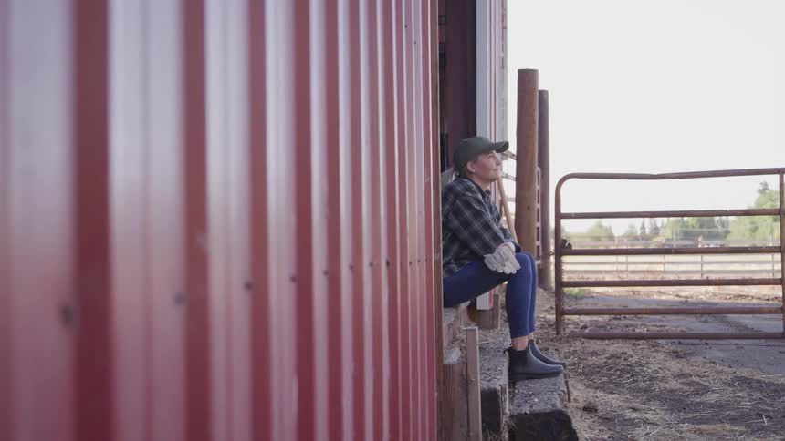 Woman sitting on a farm ranch