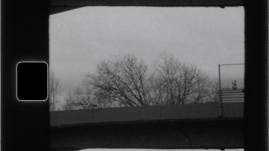 Silhouette of vehicles passing on a concrete bridge on a cloudy day