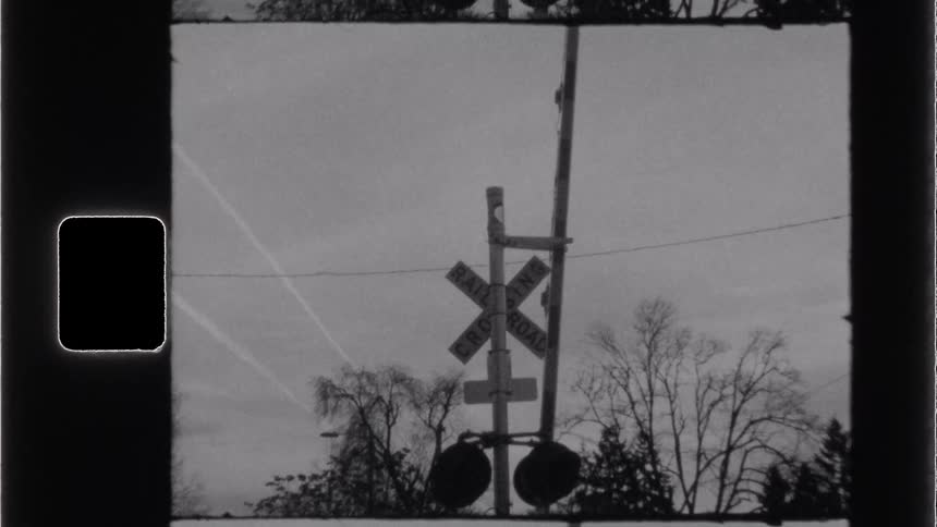 A railroad crossing sign is in town