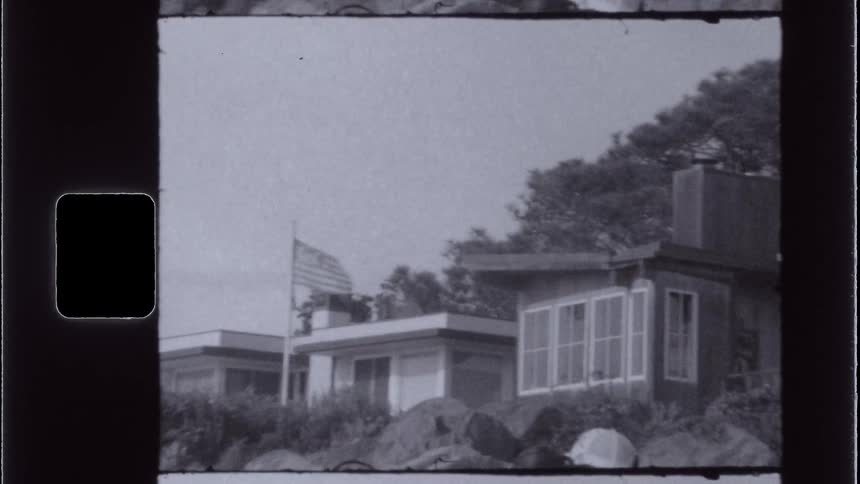 Vintage suburban homes with us flag in black and white film still