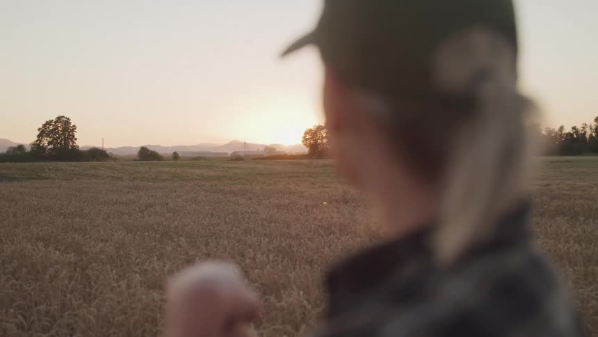 Woman in cap in a farm field in a morning