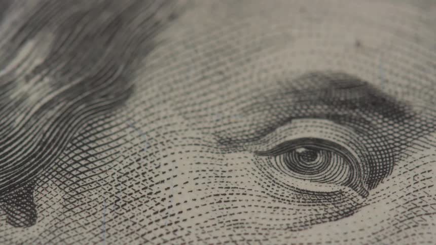 Shots of close ups of a hundred dollar bill