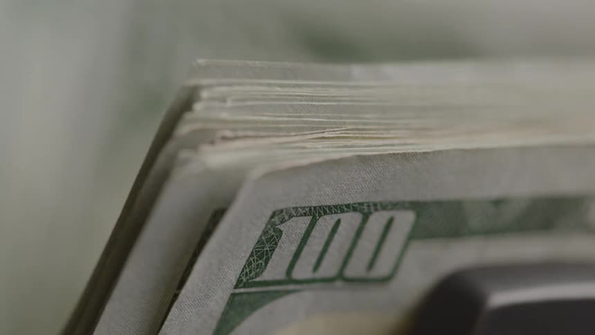 Banknotes stacked in a machine
