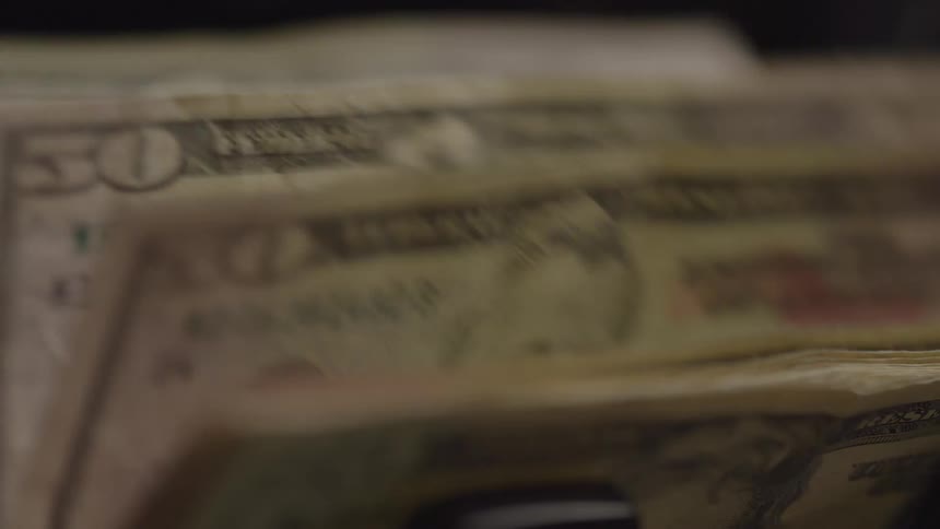 A bill counter counts a series of 100dollar bills