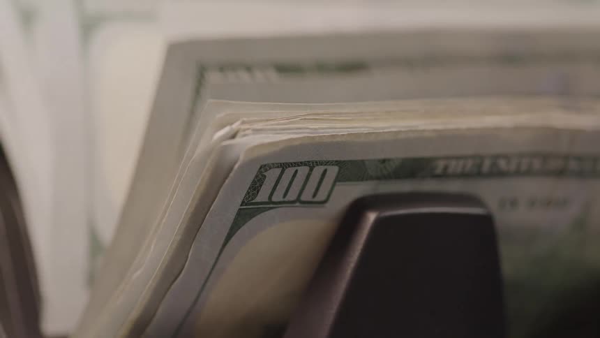 A bill counter counts a series of 100dollar bills