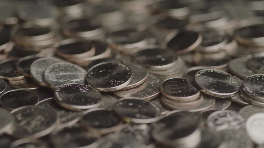 Several coins stacked on a surface