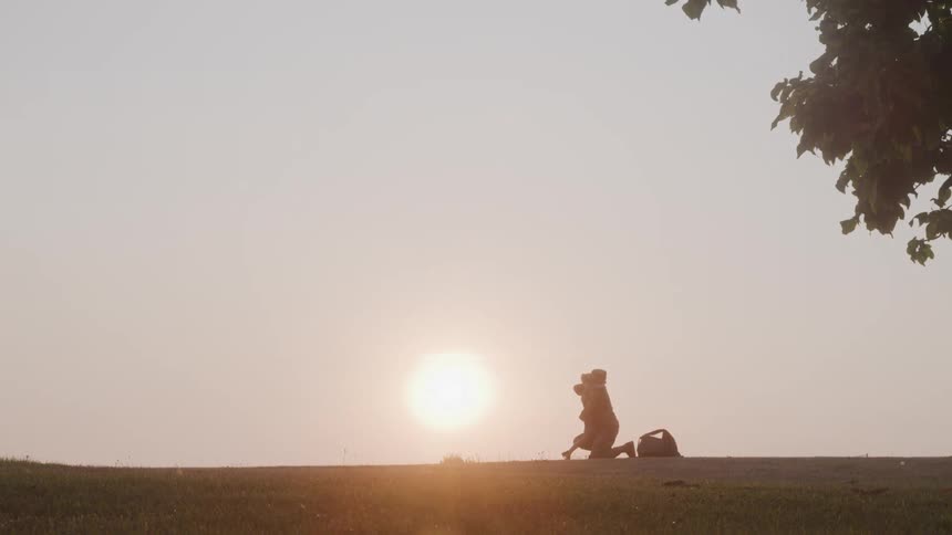 Military mother running across a field and kneeling down with her daughter running and hugging her