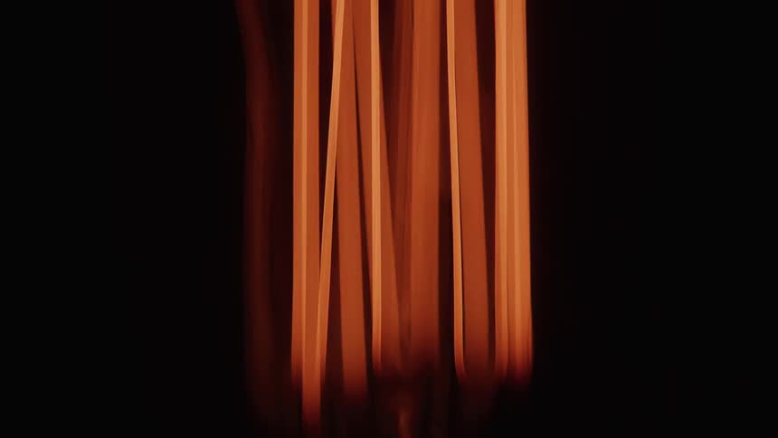 Orange glowing wires from a lit light bulb