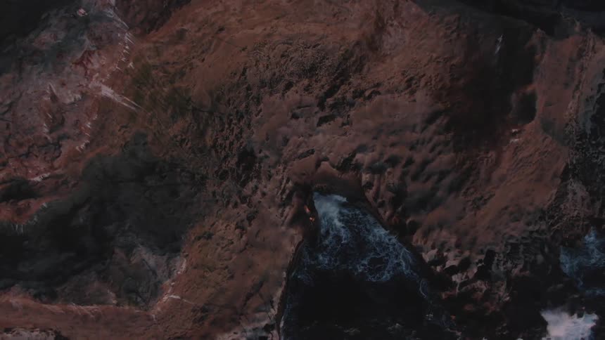 Waves hit the rocks of a mountainous coastal area