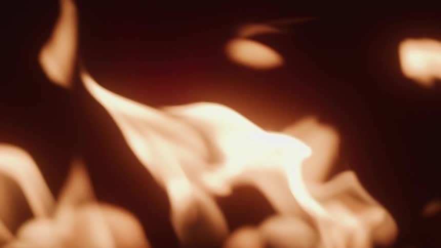 Flames of fire rising against a dark background