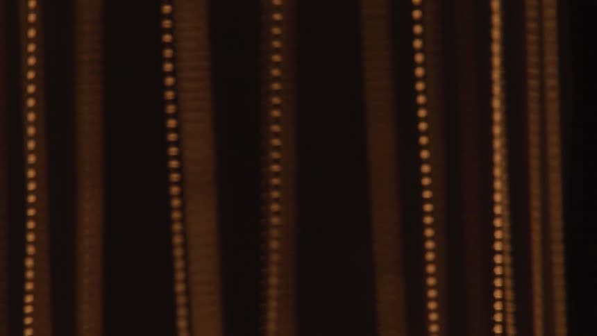 Abstract moving curtain against a dark background