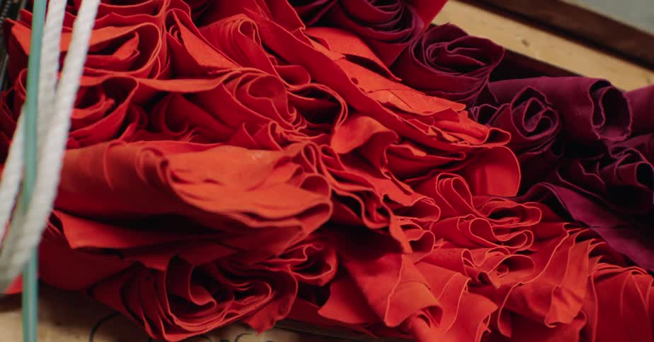 Fabrics in shades of red and purple on a wooden cabinet