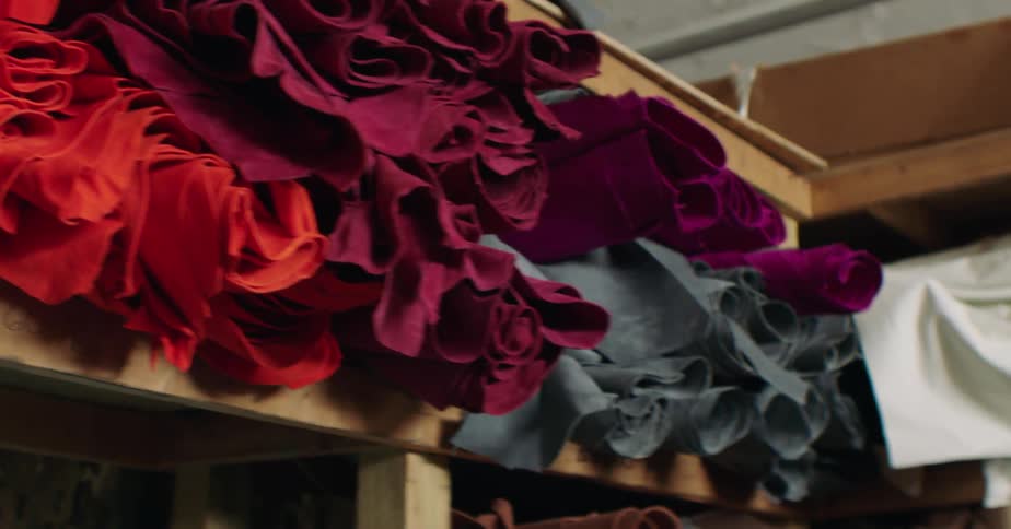 Colorful fabrics on wooden shelves