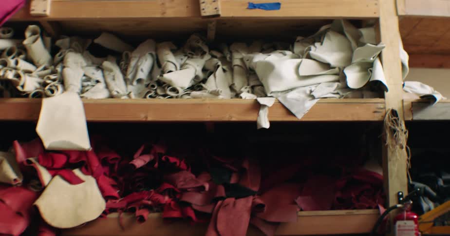 Fabrics of different colors on a disorganized shelf
