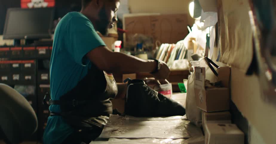 Man working manually in the production of a shoe