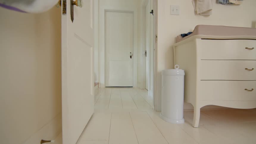 The boy follows the dog into the room