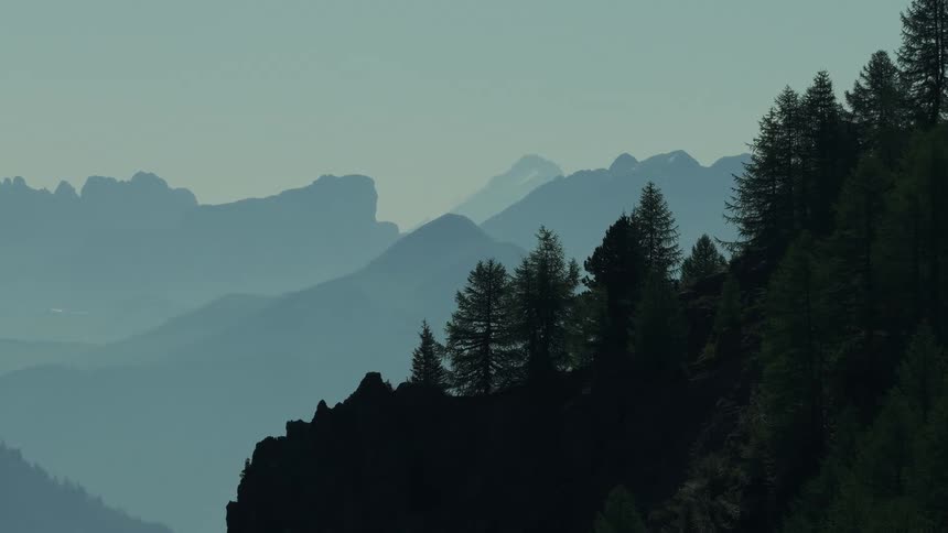 Aerial Reveal of Layered Mountain Ranges in the Distance