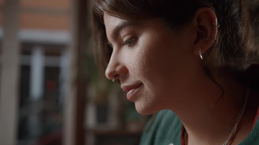 A smiling woman facing left