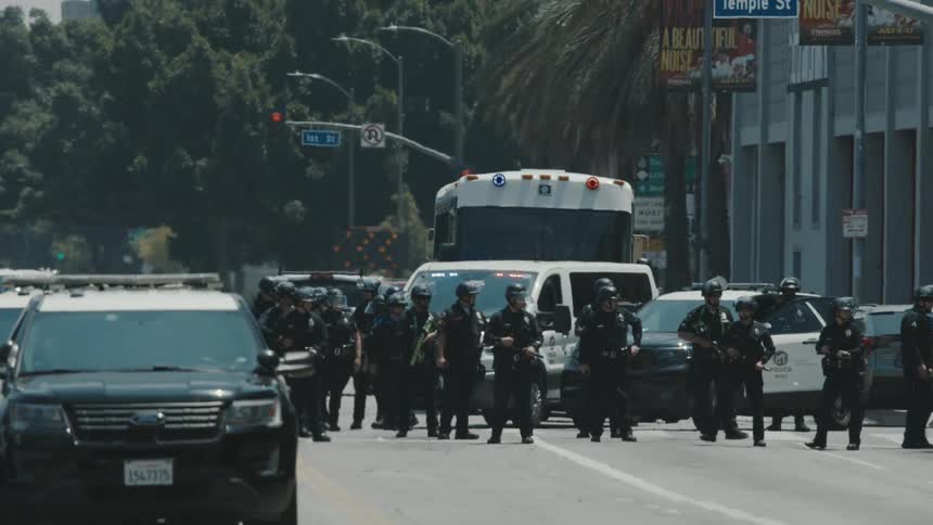 Large group of police officers closing off an urban street