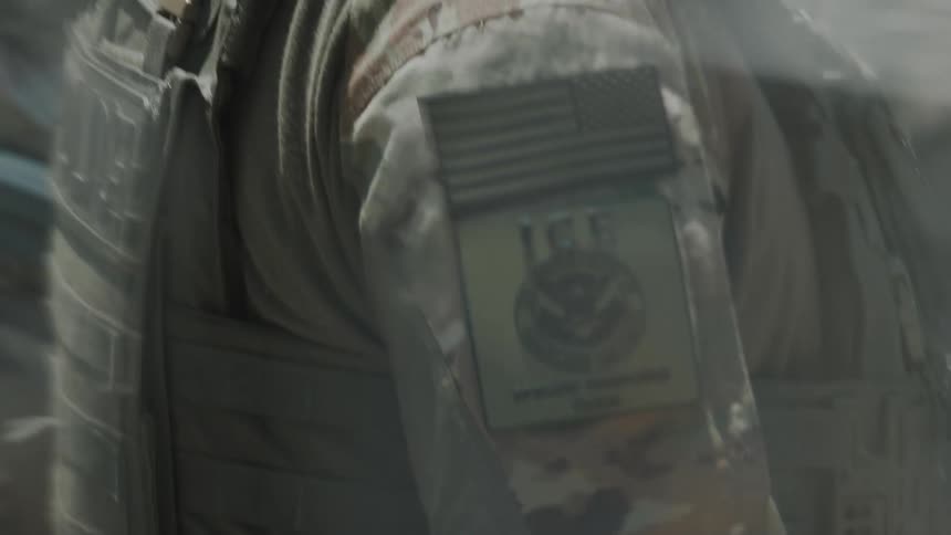 The officer is wearing a camouflage uniform