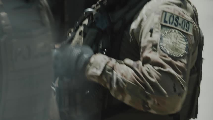 ICE agents in uniform and carrying specialized weapons