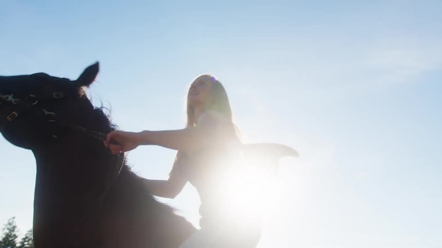 The woman jumps up on her horse