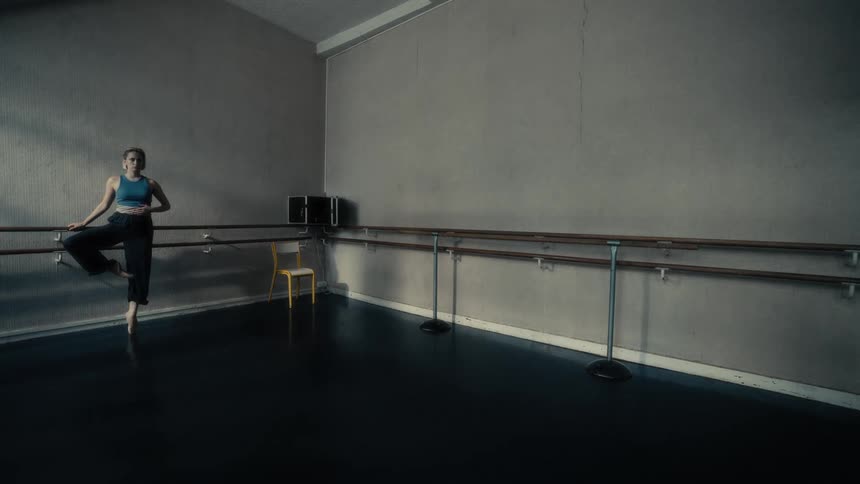 The woman is practicing in the ballet hall