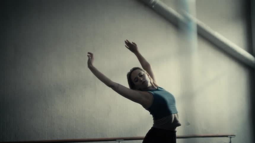 Blonde woman dancing in an indoor space