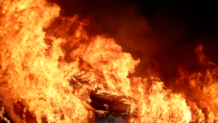 A raging fire consuming a building at night