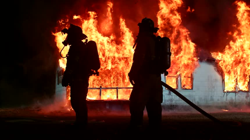 Firefighters put out a building that is in flames