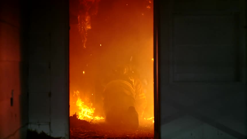 The firefighter crawls through the burning home