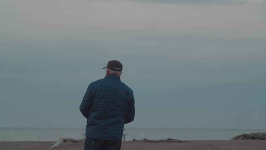 Man taking a photo on a quiet beach