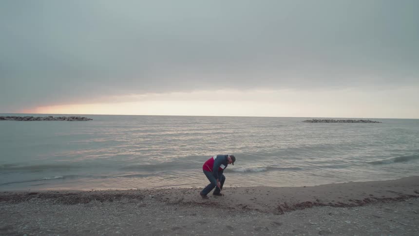 Man walking on the sand at the beach