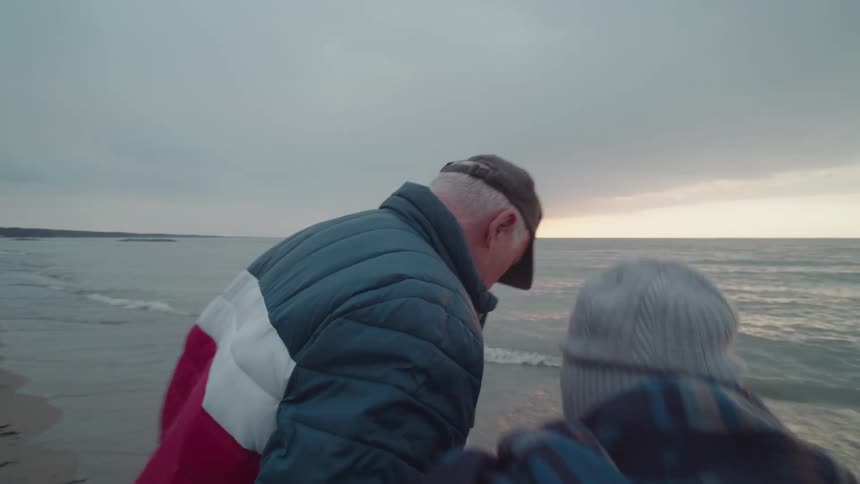 Man and a woman on a beach on a cloudy day