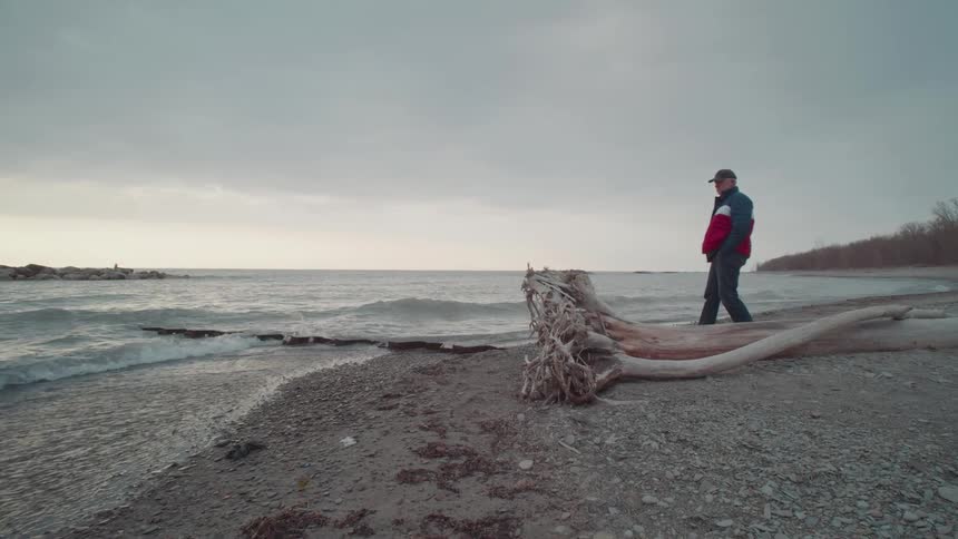 Man and woman walking on the sand at the seaside of a winter beach