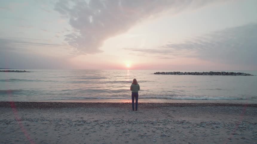 Woman walking on a beach one morning