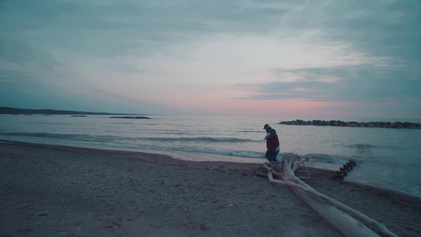 Couple holding hands walking along the beach one morning