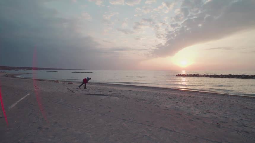 Isolated person on a beach at dawn