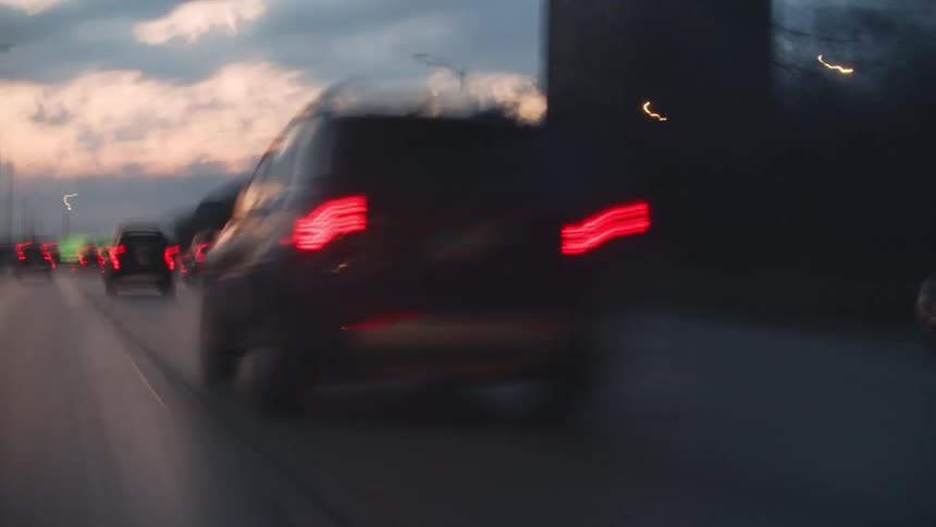 Hyper lapse of traffic moving down a busy freeway at dawn