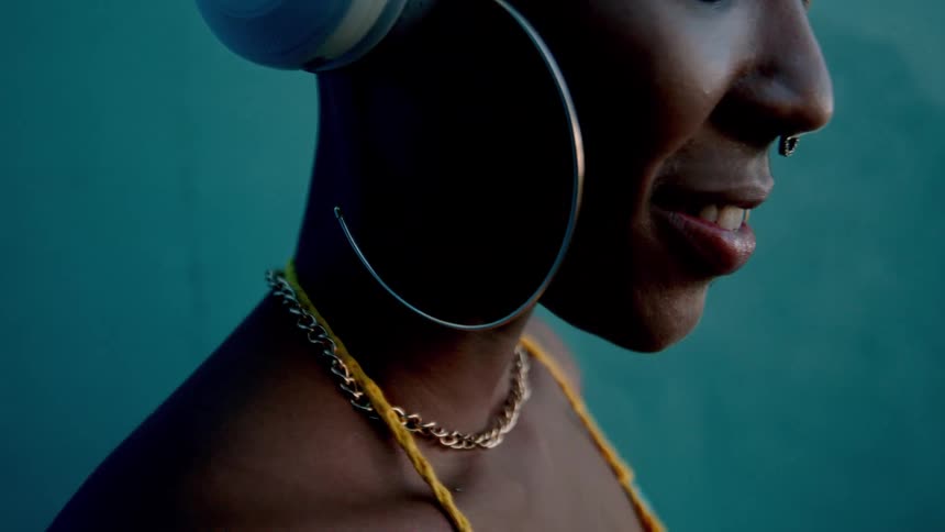 Woman enjoying music on white headphones
