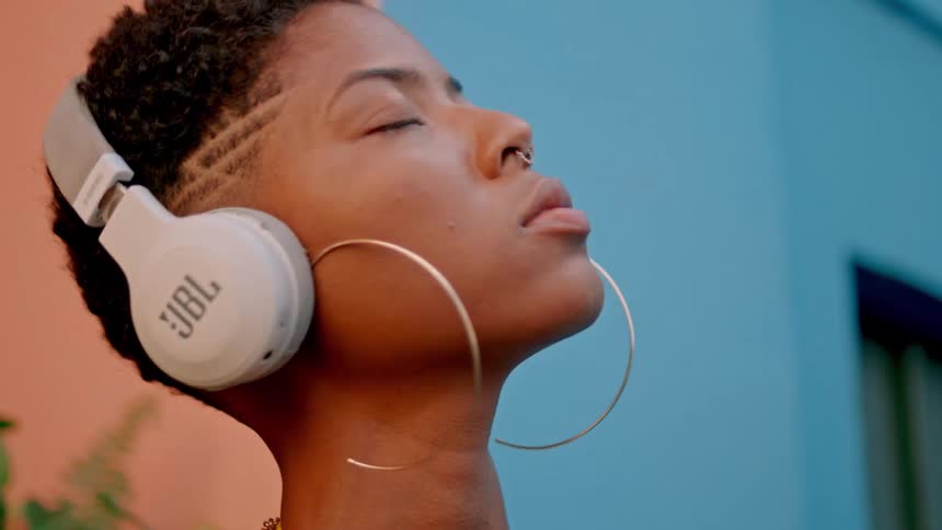 Woman with white headphones enjoying