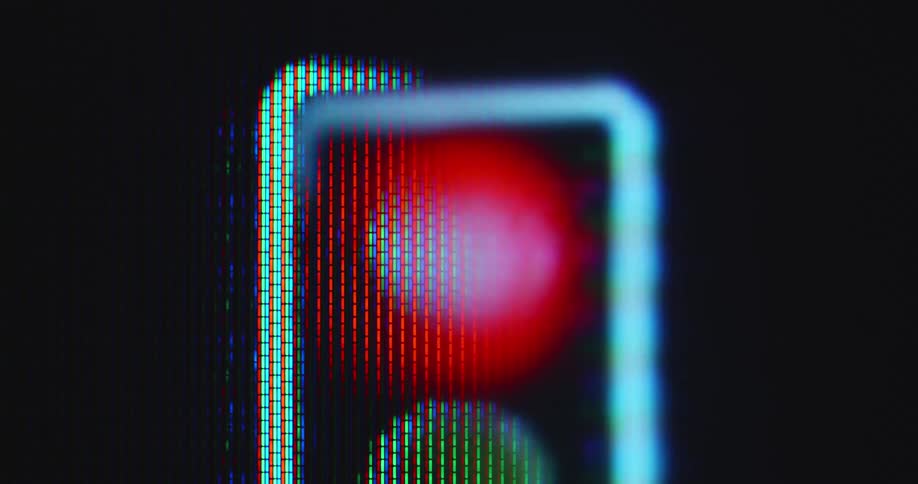 Extreme macro close up of the red light of a traffic light animation that flashes and glows brightly symbolizing a stop signal or stop light to stop driving or end a process of any kind