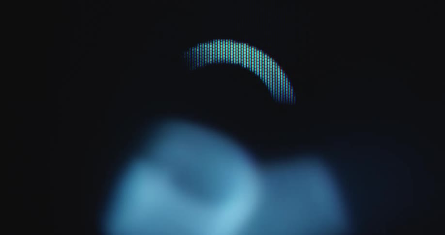 Closeup showing a rotating loading arrow icon or emoji spinning on a black computer screen while the old and outdated pc is struggling to load or boot a program or software which is not updated or supported anymore