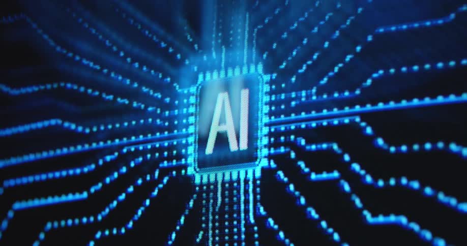 A glowing blue computer chip with ai on its surface sends pulses of light through a futuristic digital circuit board while data and information is processed and gathered in a digital virtual reality hologram