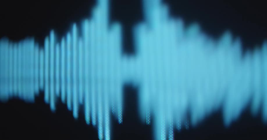 Symmetrical audio or music sound equalizer animation or motion graphic being displayed on a screen with black background and visible RGB pixels symbolising the sense of hearing or sound perception in the digital age
