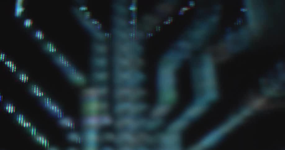 Detailed macro shot of a data flow animation with Bitcoin orange light dots symbolizing information flowing and being transmitted through data lines on a pc or computer mainboard or printed circuit board
