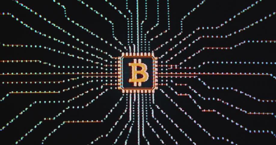Data lines connecting to an abstract orange bitcoin symbol against a black background as information flows and a block of BTC is being mined while transactions are validated in the network based on blockchain tech and decentralization